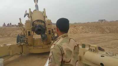 Iraqi soldier demonstrates the classic one man howitzer team, lobbing shells at IS positions near Mosul - 2017