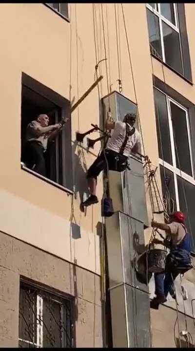 Old man surprised to see workers outside his window