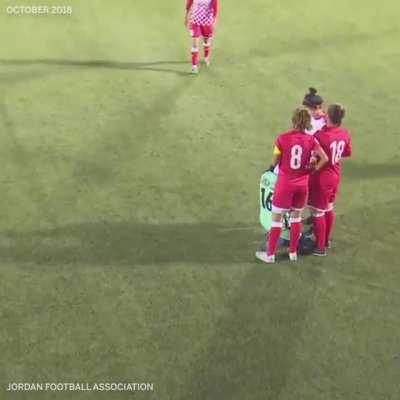 When a soccer player's hijab started falling off to reveal her hair, opponents circled around her while she fixed it.