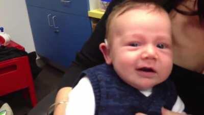 Deaf baby smiles after hearing parents' voices for the first time