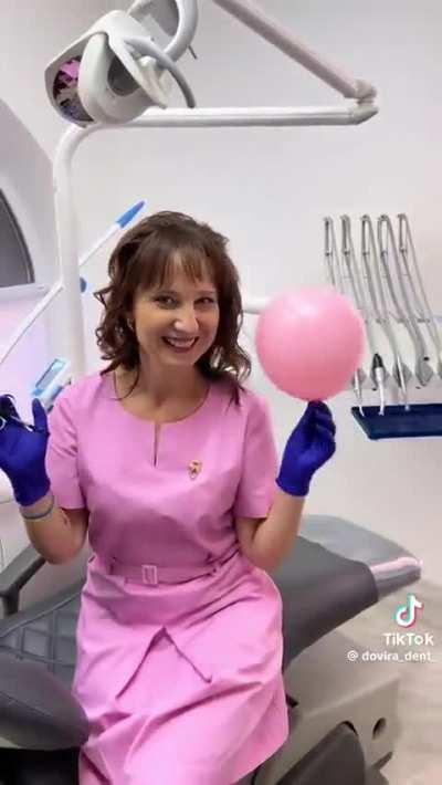 Health workers showcasing their ability to inject a balloon without bursting it