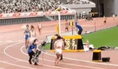 Cameraman entered the track area and stretched out a cable in front of an oncoming athlete, who collided with it.