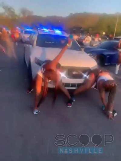 Twerking in front of a cop car