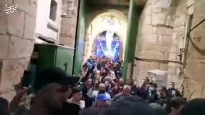 Zionists tried to forbid the Palestinians of Jerusalem from entering the holy Aqsa mosque and closed its doors. The Palestinians forced their way through and opened the doors of the mosque.