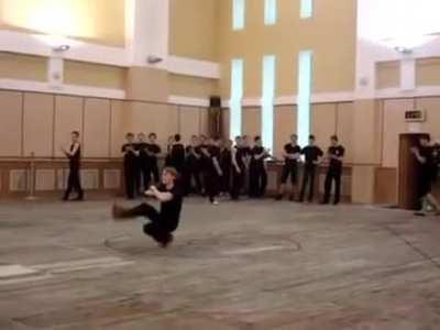 Russian guy squat-kick dancing insanely fast