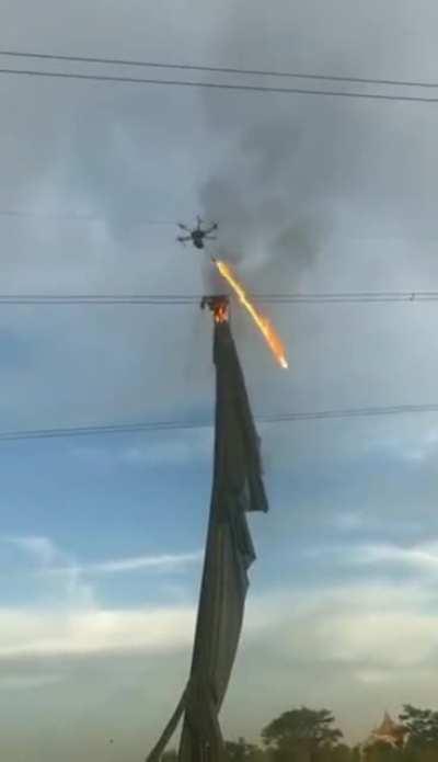 Drone equipped with flamethrower clearing the power lines