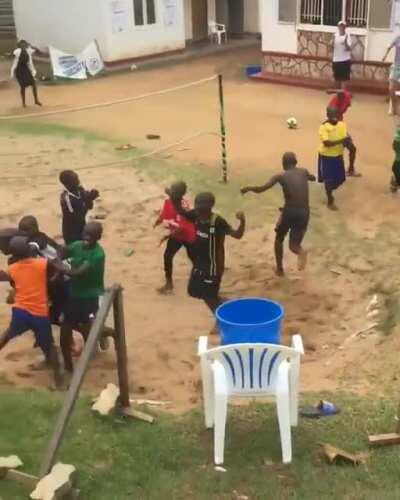 Kids attempting to head a football into the bin.