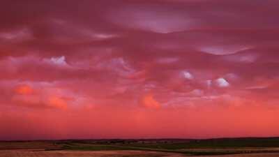 Clouds that look like ocean waves under water, gradually changing colour over time