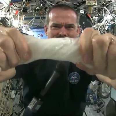 This is what happens when you wring out a soaking wet towel in zero gravity 