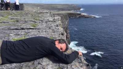 Guy with fear of heights gets the courage make it to the cliffside view