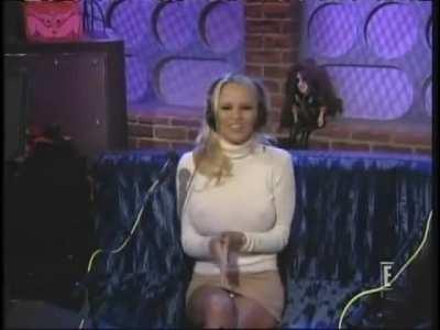 Pamela Anderson wearing a tight sweater with no bra and a very short skirt in a 2003 Howard Stern interview.