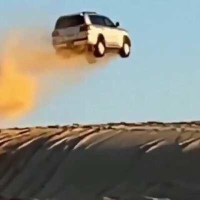 car flies over in the desert