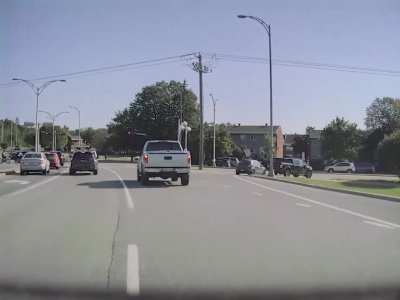 Still the car driver's fault but the truck driver didn't have to yield. There was plenty of time for both of them to pass before the wave of cars.