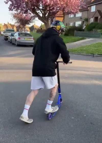 A guy pulls off a great flip on a scooter