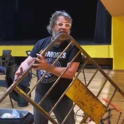 Catalan musician Xavier Lozano playing a flute made from a street barricade.