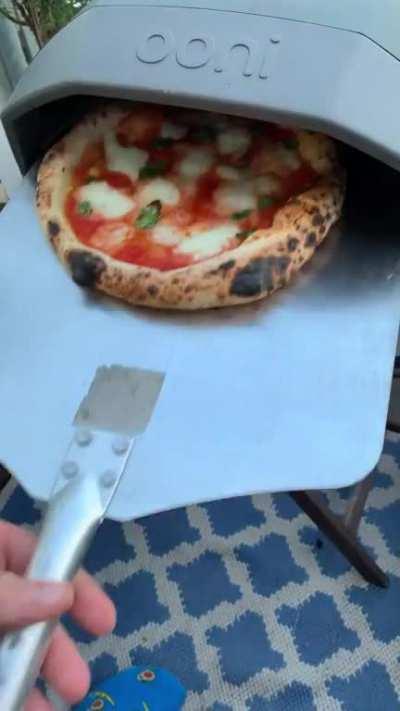 Homemade sizzling Pizza coming fresh out of the oven