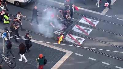 French railway workers sell barbecue on tracks while participating in a nationwide strike