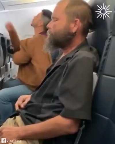 Guy lights a cigarette on plane