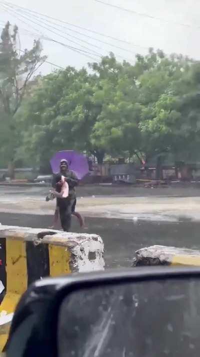 a man catching a fish in the middle of one the biggest floods in chennai