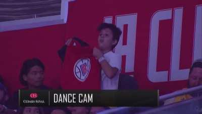 Kid baits NBA camera and flashes free Hong Kong shirt