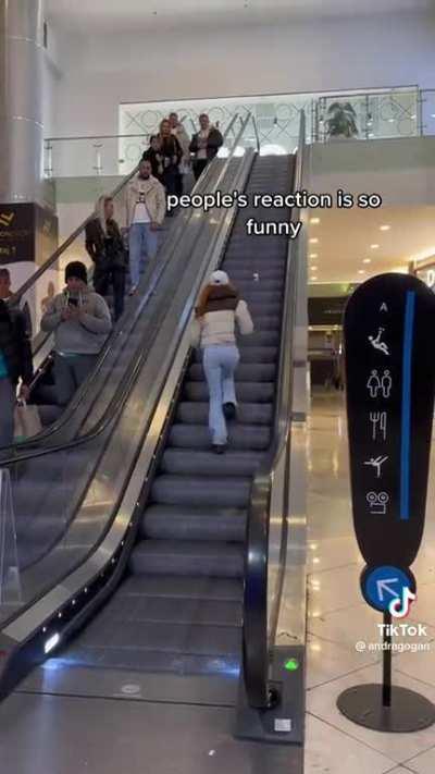 woman on tiktok using entire escalator for her tiktok