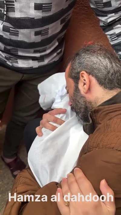 A Palestinian bids farewell to his child who was martyred in the ongoing israeli airstrikes that target children