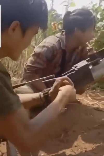 Myanmar anti-junta resistance shooting dynamite sticks from a catapult/slingshot