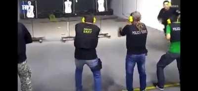 Trainer acting as a nonthreatening civiling during a live police firing range. 