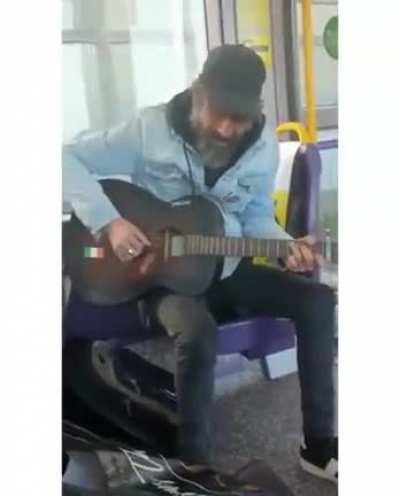 Busker entertains autistic child by performing 