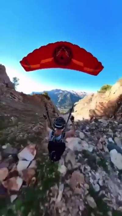 Skydiver glideing close to Mountain and doing 360°s