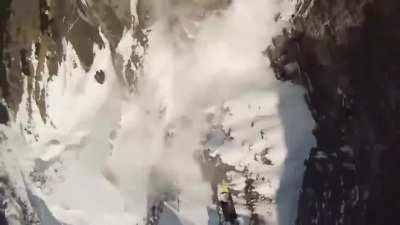 Skier creates an avalanche on purpose, then proceeds to jump off a cliff so he can observe the avalanche from a distance