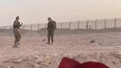 Israeli soldiers dancing with Egyptian soldiers on the other side of the border