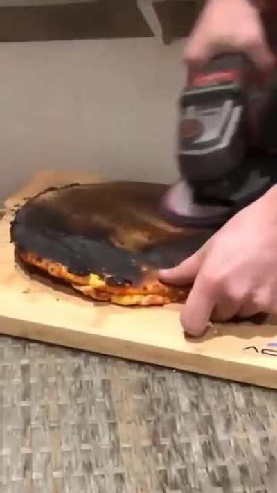 removing the burnt part of a pizza