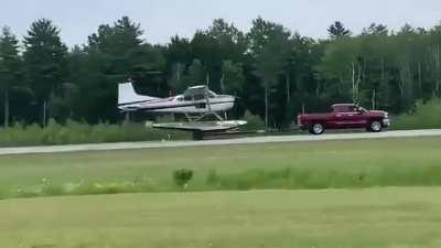 This plane taking off from a trailer being pulled by a pickup