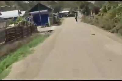 The video,attached, is from the mid June, when Meitei village was attacked in and around Sugnu area. The person making the video is a Kuki, running around the deserted street yelling “I’m happy” and showing the dead Meitei bodies killed & burnt to death. 