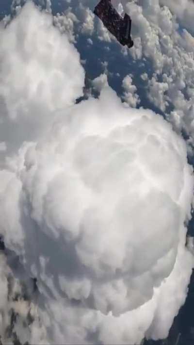 Skydiving among puffy clouds