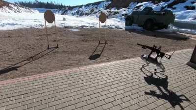 Robot dog firing a Kalashnikov assault rifle