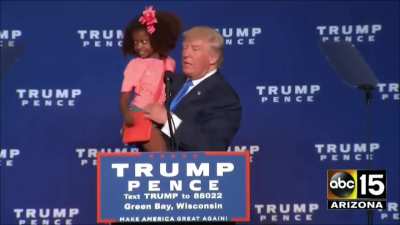 Trump tries to kiss a child on the lips