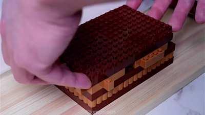 Man making a cake out of Lego