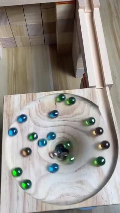 The sight and sound of draining marbles