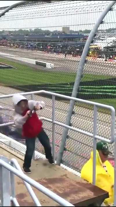 Kid experiencing strong crosswinds at a Nascar race