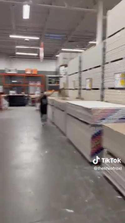 Lady uses Home Depot as her personal dog park.