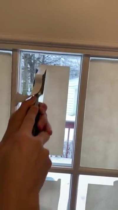 Scraping paint off glass