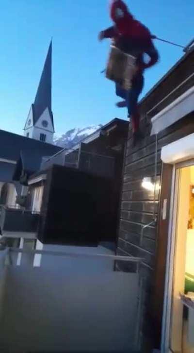 trying to play accordion hanging from a roof dressed as spiderman?