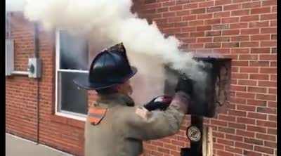 Firefighter explaining how to stop inside fire by first applying little water around the entry of enclosure.