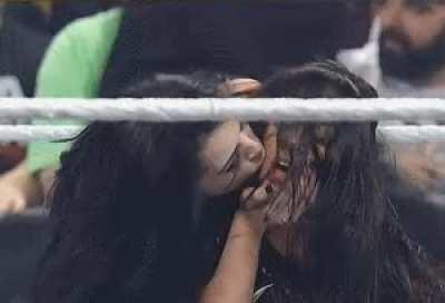 Paige gives AJ a kiss