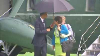 Good Guy Obama sharing his umbrella.