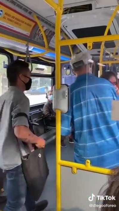 woman spits at someone on the bus