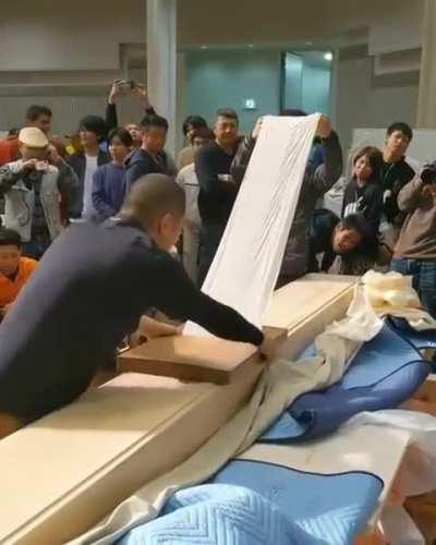 A competition to see who peels the thinnest sheet from a plane of wood