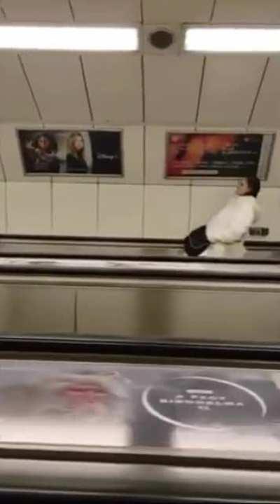 Camera angle change on escalator makes everyone look like they have interesting posture